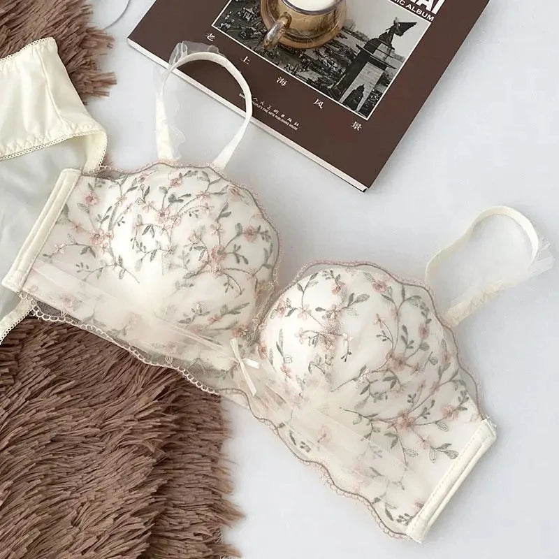 Seamless Strapless Bralette in white with floral lace detailing on a neutral background