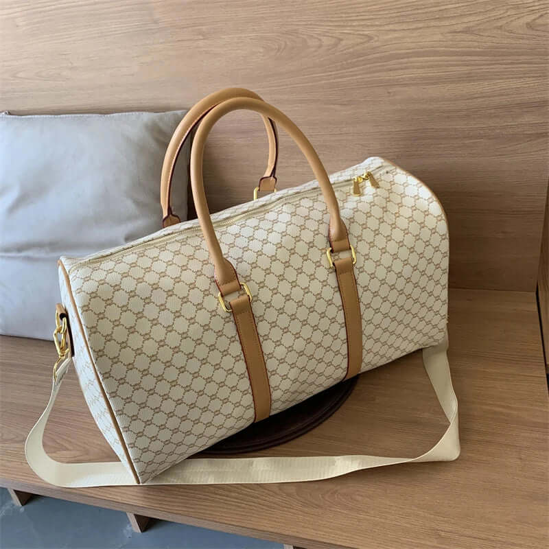 Beige patterned travel duffel bag with tan handles and a long shoulder strap.