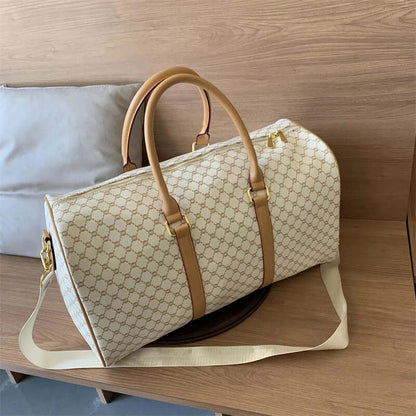 Beige patterned travel duffel bag with tan handles and a long shoulder strap.