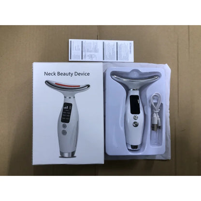Handheld facial beauty massager displayed beside its product packaging and accessories.