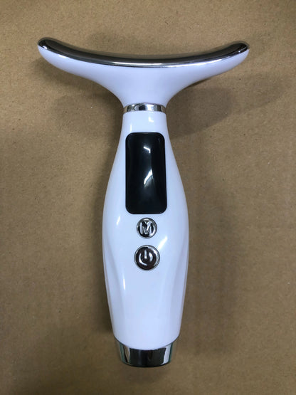 Close-up of a handheld facial massager showing its display and control buttons.