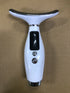 Close-up of a handheld facial massager showing its display and control buttons.